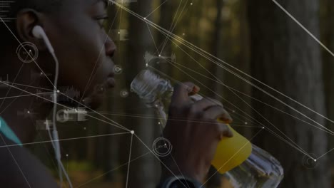 Animation-of-network-of-connections-over-woman-drinking-water-exercising-in-forest