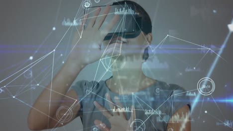 Animation-of-digital-interface-over-businesswoman-using-vr-headset