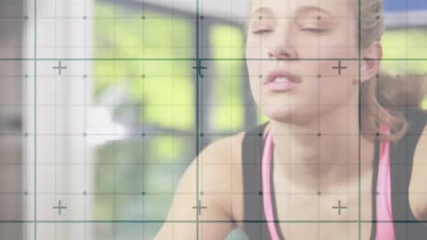 Animation-of-digital-interface-with-squares-over-woman-exercising-in-gym