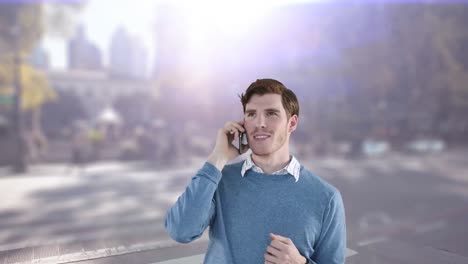 Animation-of-businessman-using-smartphone-over-cityscape-and-glowing-light