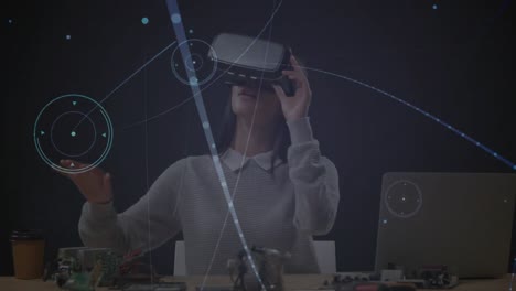Animation-of-digital-interface-over-businesswoman-using-vr-headset