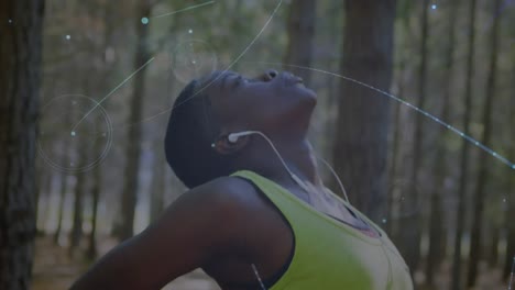 Animation-of-network-of-connections-over-woman-stretching-exercising-in-forest