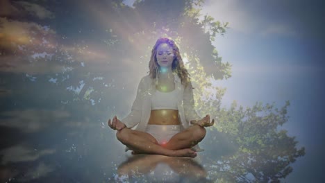 Animation-of-glowing-light-over-woman-practicing-yoga-over-tree-and-sky