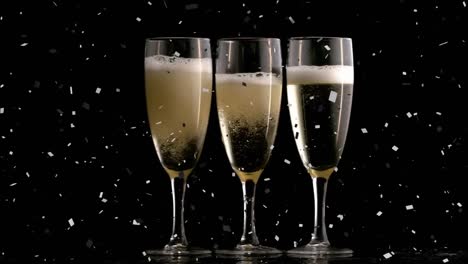 Animation-of-confetti-falling-over-glasses-of-champagne