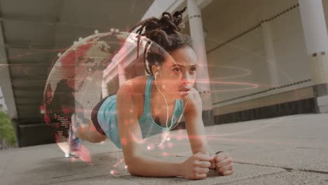 Light-trails-over-spinning-globe-against-african-american-fit-woman-performing-plank-exercise