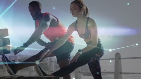 Network-of-connections-against-mixed-race-couple-performing-stretching-exercise-on-the-promenade