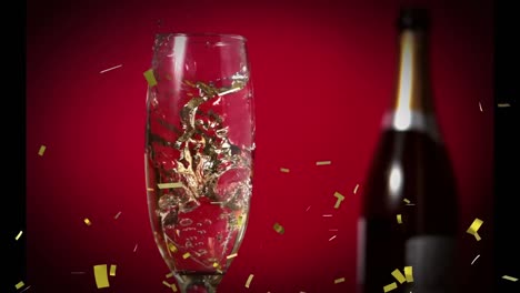 Animation-Von-Goldenem-Konfetti,-Das-über-Ein-Glas-Champagner-Fällt