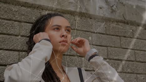 Animation-of-network-of-connections-over-fit-woman-wearing-earphones