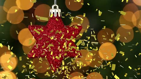 Animation-of-gold-confetti-falling-over-red-star-christmas-tree-decoration,-with-bokeh-lights-behind