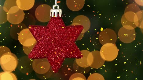 Animation-of-confetti-falling-over-red-star-christmas-tree-decoration,-with-bokeh-lights-behind