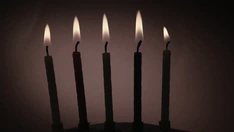Animation-of-burning-document-over-lit-birthday-cake-candles