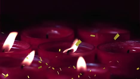 Animation-of-gold-confetti-falling-over-lit-red-candles-on-black-background
