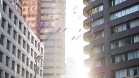 Animation-of-purple-light-flares-moving-over-modern-city-buildings