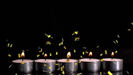 Animation-of-gold-confetti-falling-over-lit-tea-light-candles-on-black-background