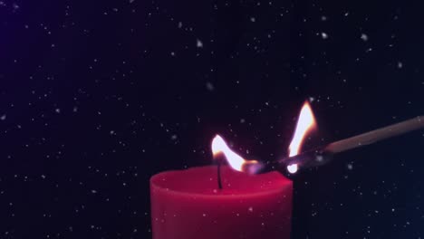 Animation-of-snowflakes-falling-over-match-lighting-red-candle-on-black-background