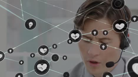 Animation-of-network-of-connections-and-icons-over-businessman-wearing-headset