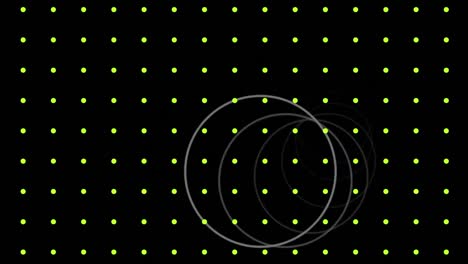 Animation-of-white-rings-moving-over-grid-of-pulsating-yellow-dots,-on-black-background