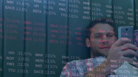 Stock-market-data-processing-against-caucasian-man-smiling-while-using-smartphone