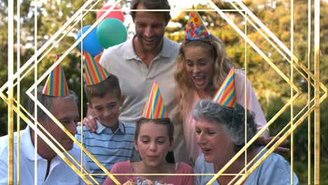 Animation-of-gold-pattern-over-happy-family-at-birthday-party