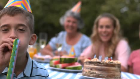Animation-of-gold-pattern-over-happy-family-at-birthday-party