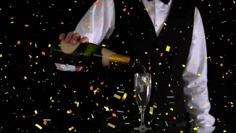 Confetti-falling-over-mid-section-of-bartender-pouring-champagne-into-a-glass-on-black-background