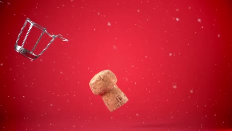 Animation-of-white-particles-falling-over-champagne-cork-on-red-background