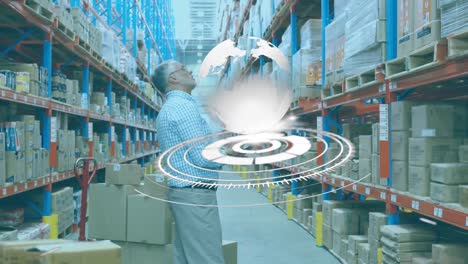 Animation-of-scope-scanning-and-globe-over-man-using-tablet-in-warehouse