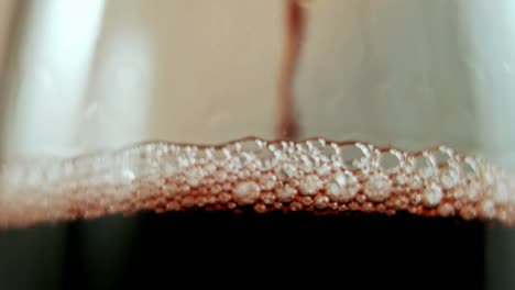 Animation-of-confetti-over-champagne-pouring-into-glass