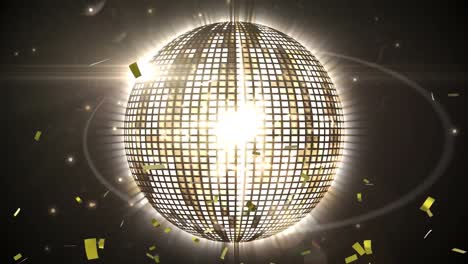 Golden-confetti-falling-over-spinning-golden-disco-ball-against-spots-of-light-on-black-background