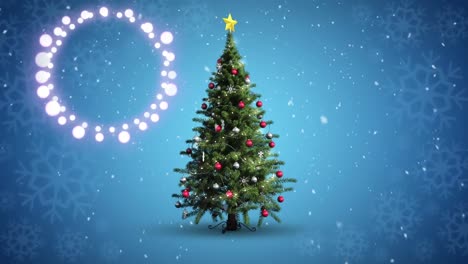 Decorative-shining-lights-against-snowflakes-falling-over-christmas-tree-spinning-on-blue-background