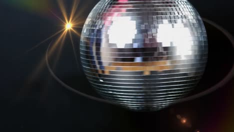 Animation-of-yellow-light-moving-over-spinning-disco-mirror-ball