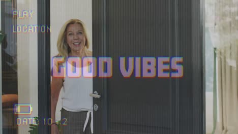 Animation-of-good-vibes-text-on-video-camera-screen-with-digital-interface-and-woman-smiling