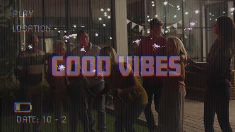 Animation-of-good-vibes-text-on-video-camera-screen-with-digital-interface,-friends-and-sparklers