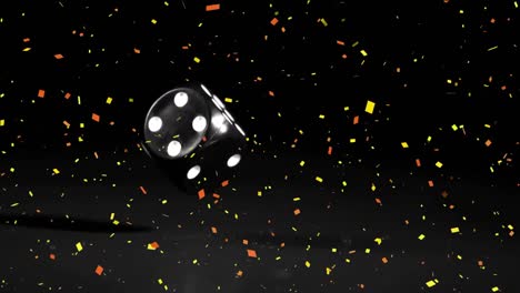 Confetti-falling-over-black-casino-dice-falling-against-black-background