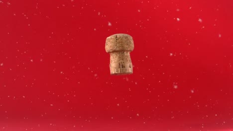 White-particles-floating-over-wine-cork-falling-against-red-background