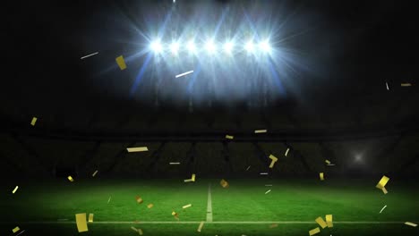 Golden-confetti-falling-against-flood-lights-and-sports-stadium-in-background
