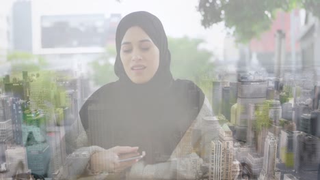 Animation-of-asian-woman-in-hijab-using-smartphone-over-cityscape