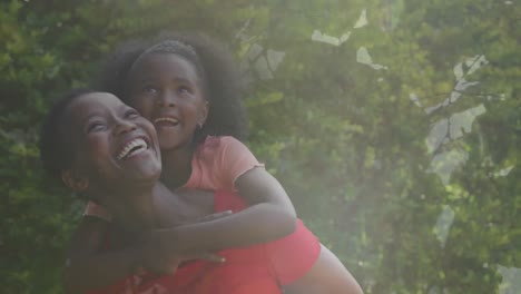 Animation-of-smiling-african-american-mother-piggybacking-daughter,-over-forest