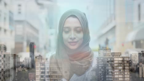 Animation-of-asian-woman-in-hijab-smiling-over-cityscape