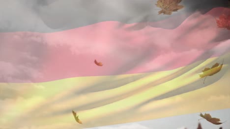 Composición-Digital-De-Alemania-Ondeando-Bandera-Sobre-Hojas-De-Otoño-Cayendo-Contra-Las-Nubes-En-El-Cielo
