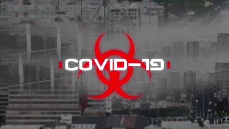 Animation-of-covid-19-warning-text-over-cityscape