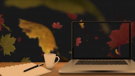 Desktop-computer-and-office-equipment-on-a-table-against-autumn-maples-leaves-floating-in-background