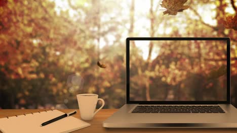 Animation-of-leaves-falling-over-laptop-and-forest
