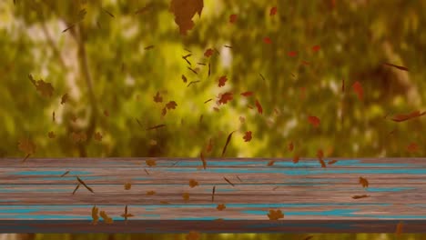Digital-animation-of-multiple-autumn-leaves-floating-over-wooden-surface-against-forest