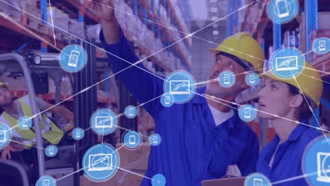 Network-of-digital-icons-on-caucasian-male-supervisor-and-female-worker-checking-stock-at-warehouse