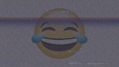 Digital-animation-of-tv-static-effect-over-laughing-face-emoji-against-grey-background