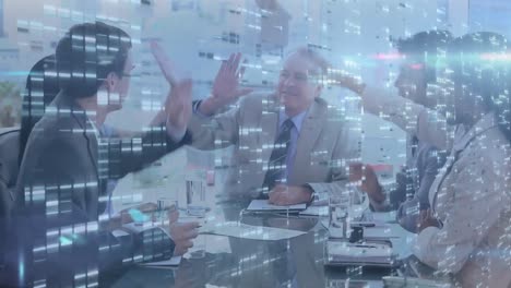 Screens-with-mosaic-squares-over-businesspeople-high-fiving-each-other-in-a-meeting-room-at-office