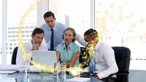 Golden-shooting-star-against-diverse-businesspeople-using-laptop-at-office