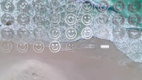 Digitale-Komposition-Aus-Reihen-Mehrerer-Emojis-Mit-Lächelnden-Gesichtern-Vor-Der-Luftaufnahme-Des-Strandes