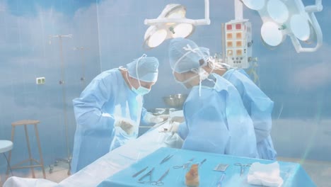 Animation-of-clouds-and-sky-over-surgeons-wearing-face-masks-in-hospital